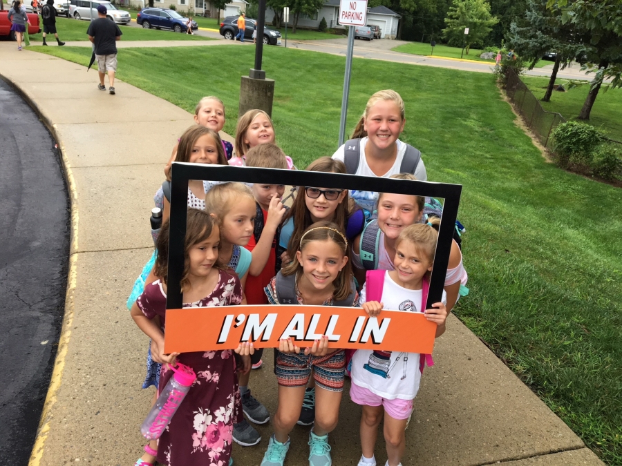 people holding a frame sign